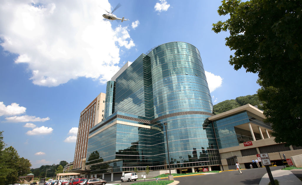 Carilion Roanoke Memorial Hospital from ground level with Life-Guard helicopter leaving helipad