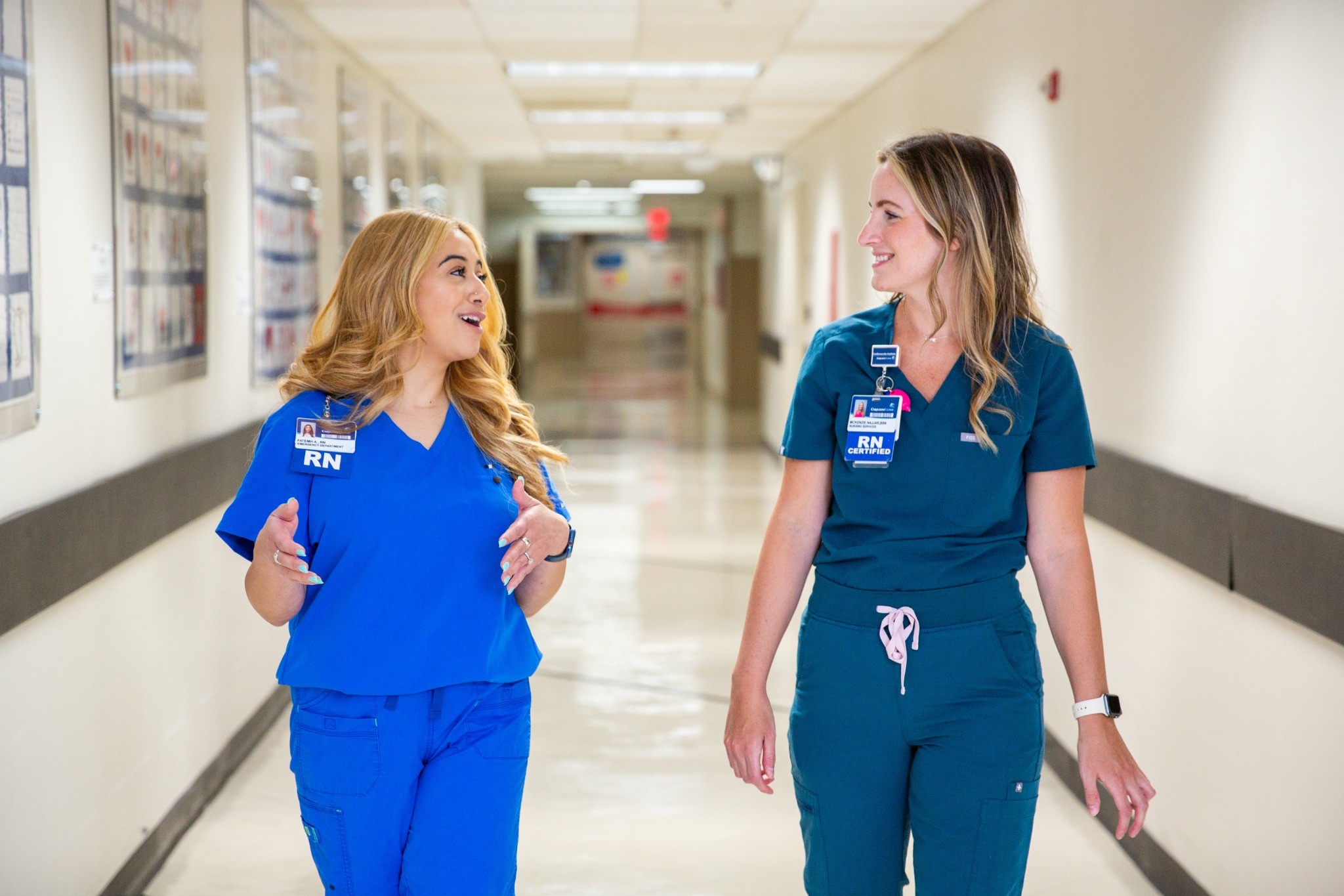 Two nurses walking in a hallway