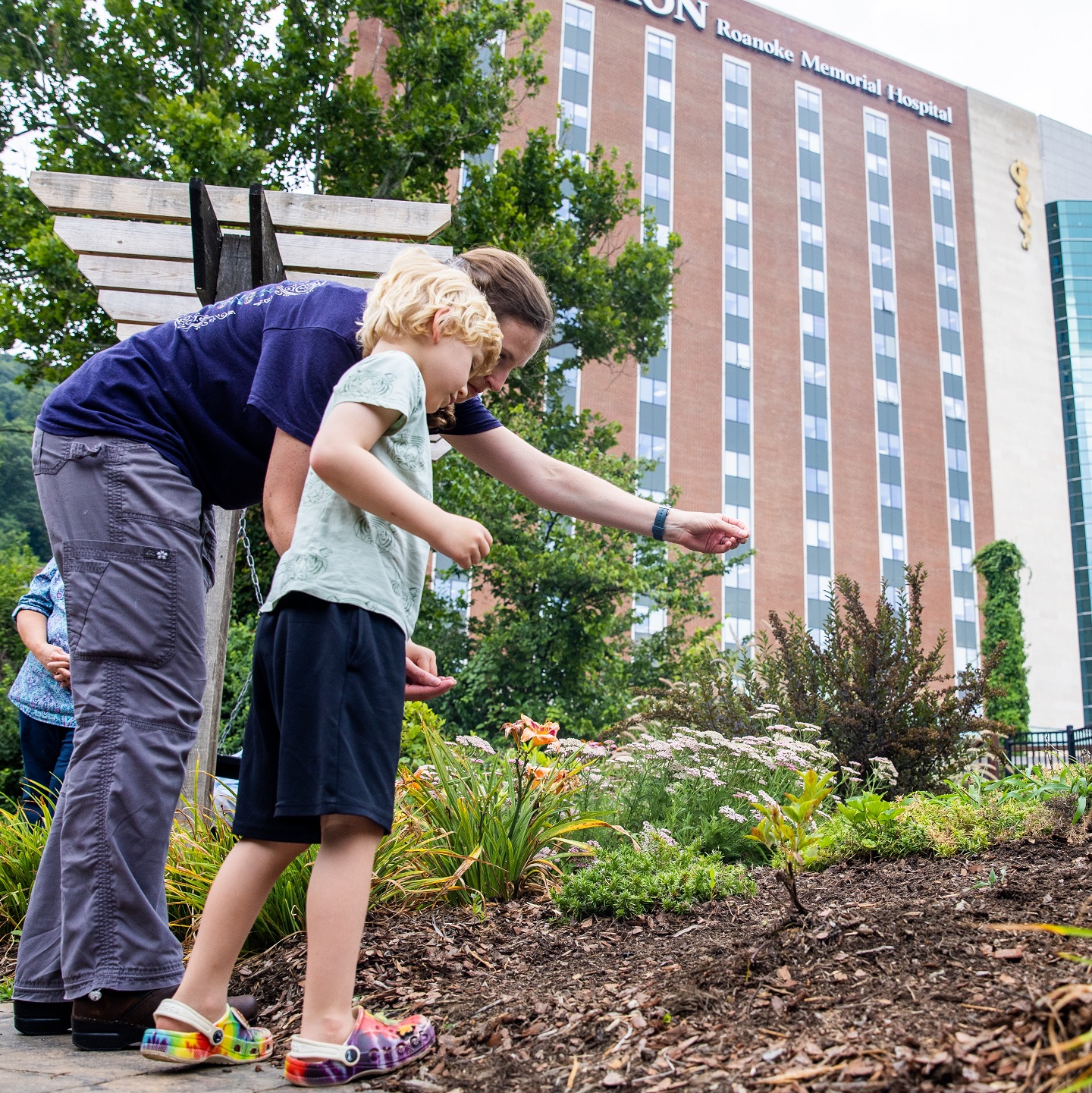 child sowing seeds in memory of lost sibling at Carilion Clinic remembrance ceremony
