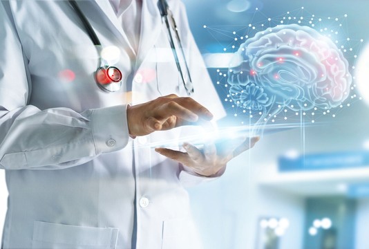 physician with computer tablet and brain image beside